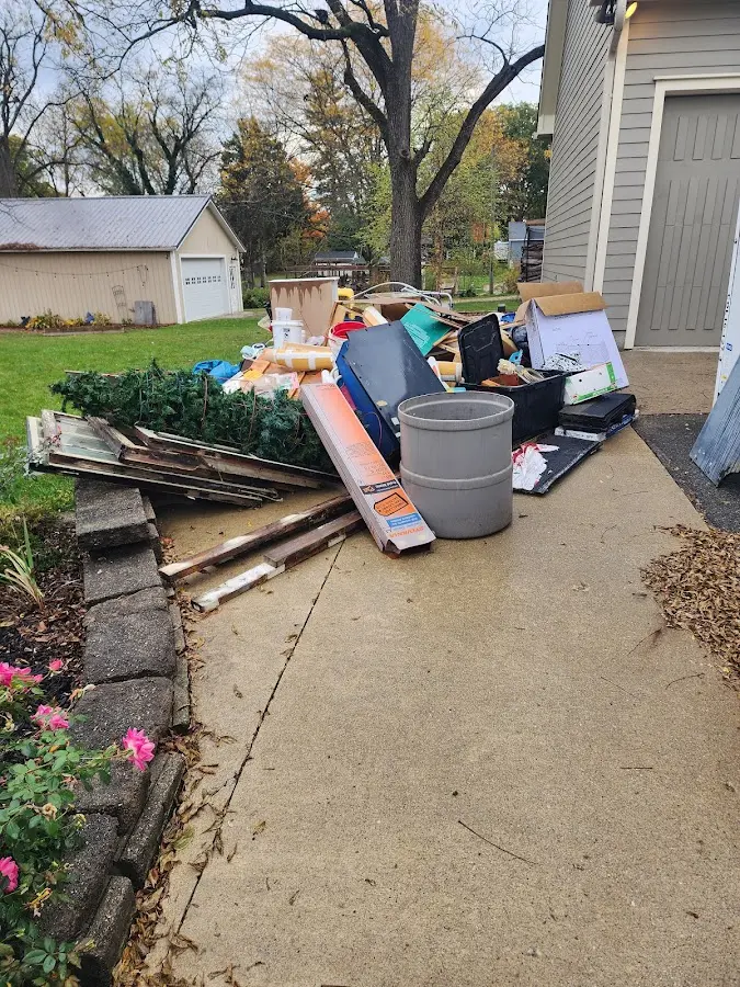Dumpster being loaded with debris for 3 Yard Dumpster Rental in La Joya